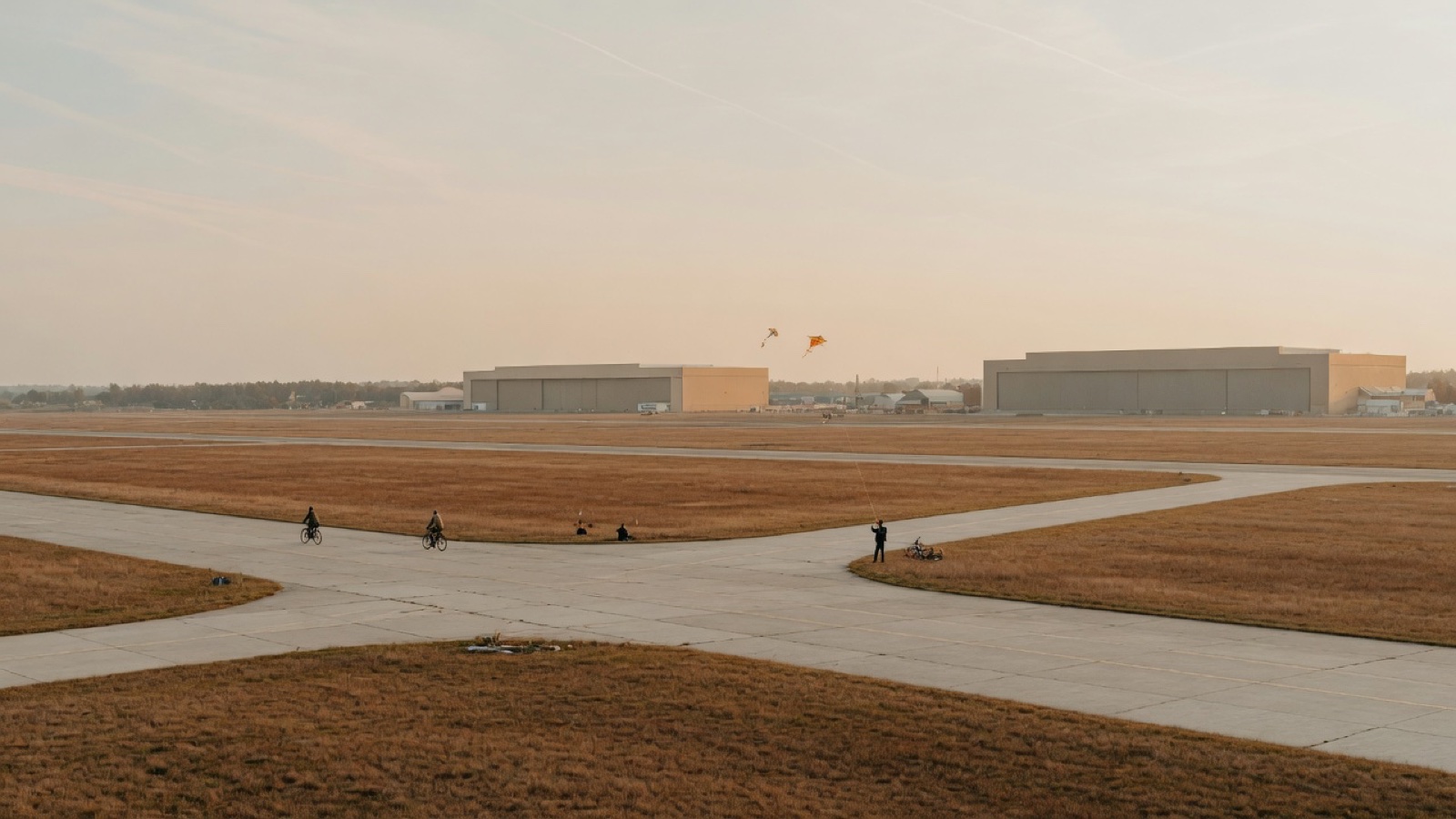 Wide open former airport field at Tempelhofer Feld Berlin under soft evening light